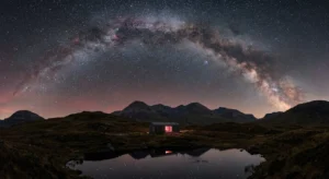 Eco-friendly stargazing cabin in Scotland under a clear Milky Way sky, regenerative travel